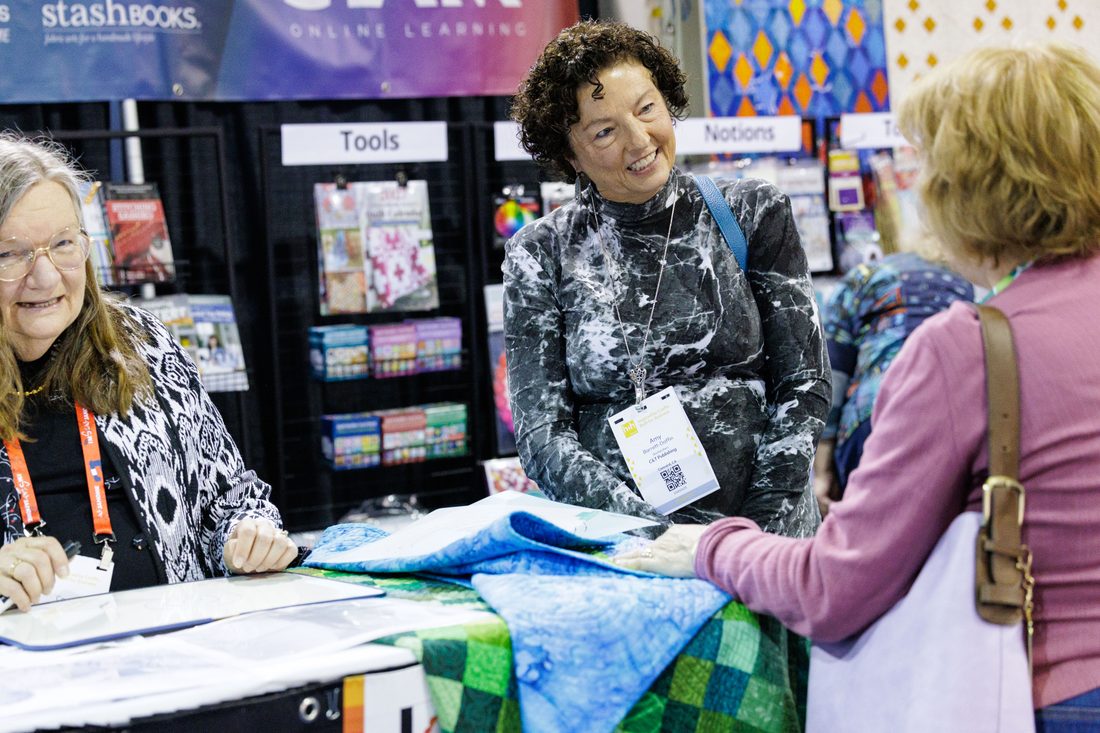 Quilter at an exhibitor booth